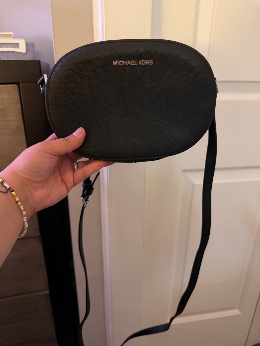 Michael Kors Black Oval Saffiano Crossbody with Silver Logo (hardware flaw)